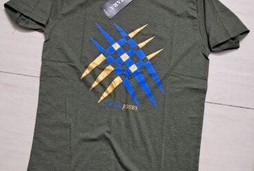 a green shirt with blue and yellow design on it